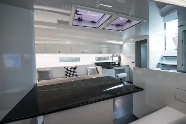 Sn Yacht Photos Pics Luxurious interior of 2015 Vismara V62 Mills yacht with modern kitchen and seating area.