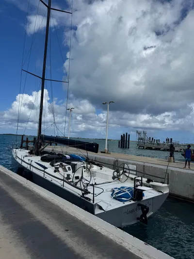 Sn Yacht Photos Pics Sailing yacht Vismara V62 Mills 2015 docked at a marina under cloudy skies.