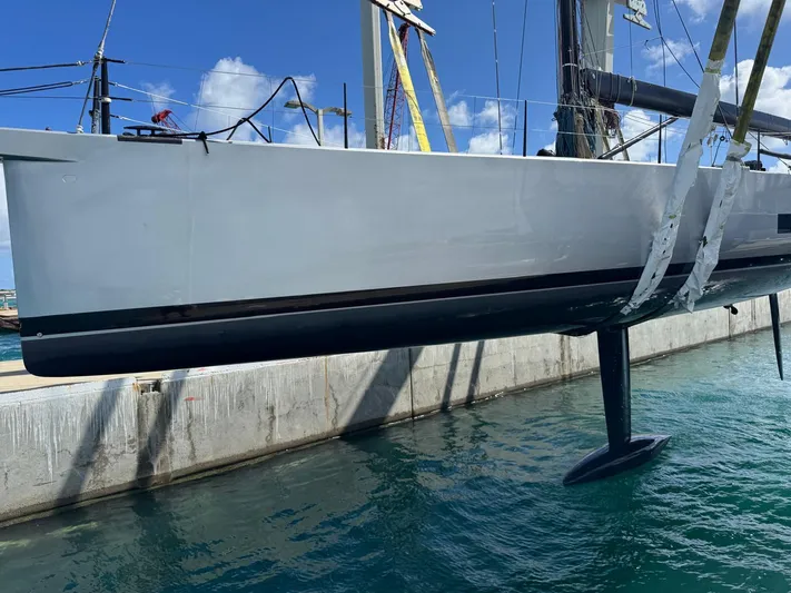 Sn Yacht Photos Pics 2015 Vismara V62 Mills yacht suspended above water, showcasing sleek hull design.