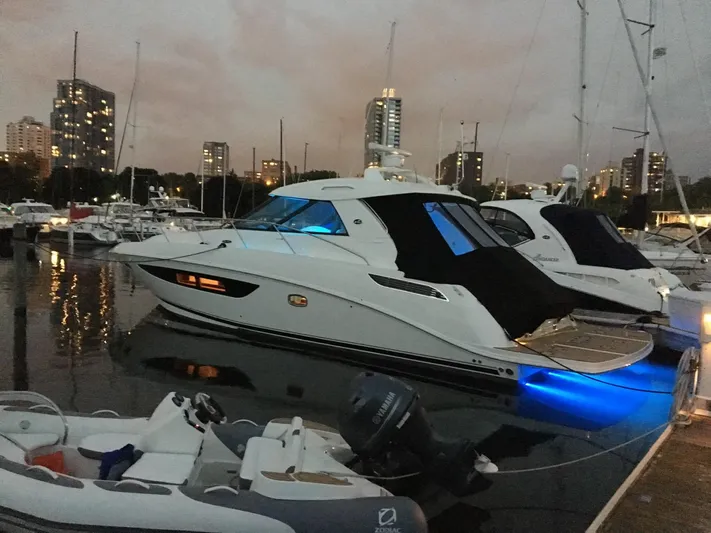  Yacht Photos Pics 2013 Sea Ray 450 Sundancer yacht docked at marina during evening.