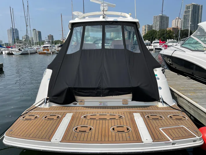  Yacht Photos Pics 2013 Sea Ray 450 Sundancer yacht docked at marina with city skyline.