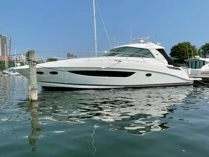  Yacht Photos Pics 2013 Sea Ray 450 Sundancer yacht docked in a marina on a sunny day.