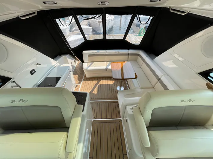  Yacht Photos Pics Luxurious interior of 2013 Sea Ray 450 Sundancer yacht with plush seating and wooden flooring.