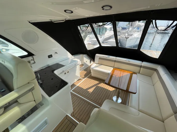  Yacht Photos Pics Luxurious interior of 2013 Sea Ray 450 Sundancer yacht with seating and table.