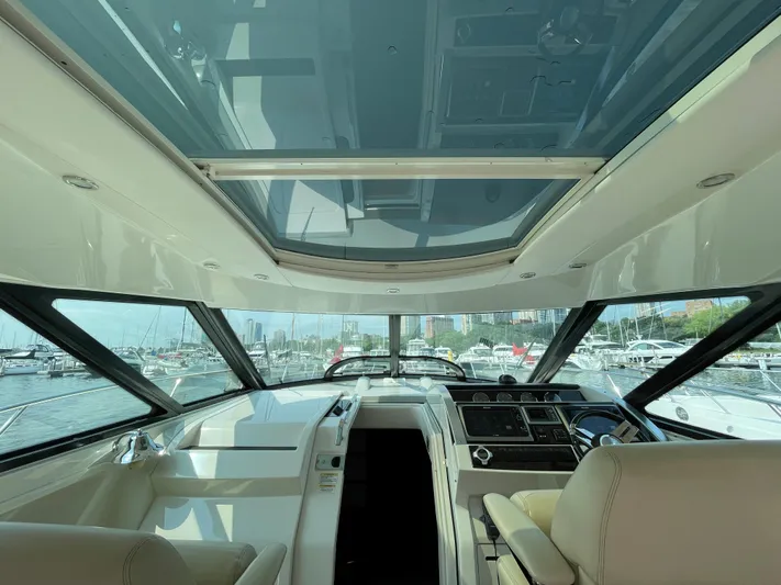  Yacht Photos Pics Interior view of 2013 Sea Ray 450 Sundancer yacht with panoramic windows and luxurious seating.