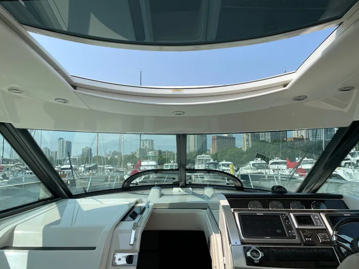  Yacht Photos Pics Interior view of 2013 Sea Ray 450 Sundancer yacht cockpit with marina backdrop.