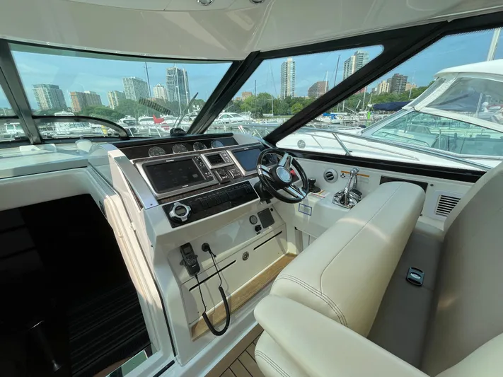  Yacht Photos Pics Helm of 2013 Sea Ray 450 Sundancer yacht with city skyline view.