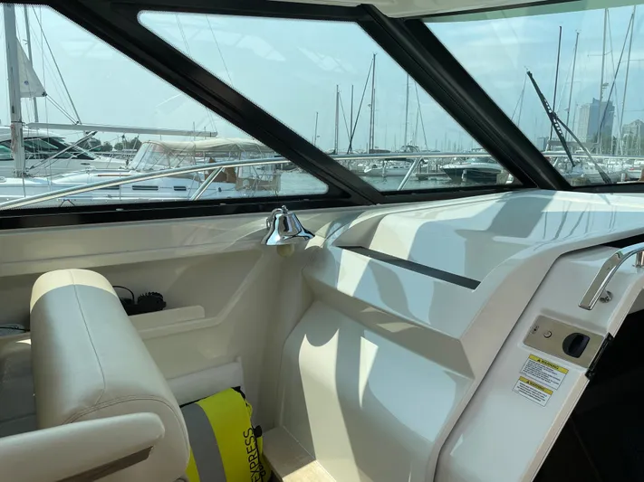 Yacht Photos Pics 2013 Sea Ray 450 Sundancer helm with marina view through large windows.