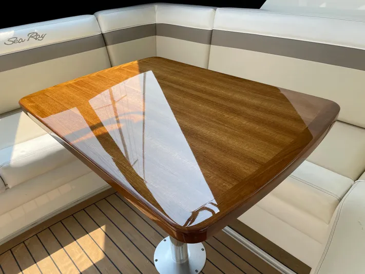  Yacht Photos Pics Luxurious seating area on 2013 Sea Ray 450 Sundancer with polished wooden table.