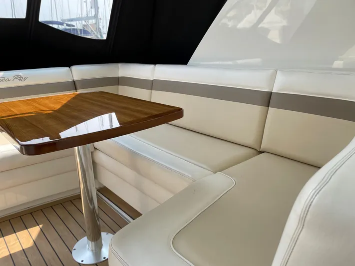  Yacht Photos Pics Luxurious seating area on 2013 Sea Ray 450 Sundancer yacht with wooden table.
