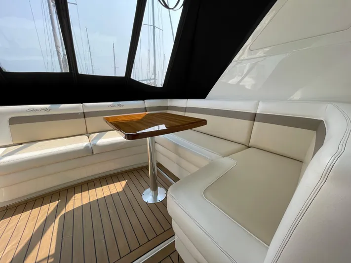  Yacht Photos Pics Luxurious interior of 2013 Sea Ray 450 Sundancer with elegant seating and wooden table.