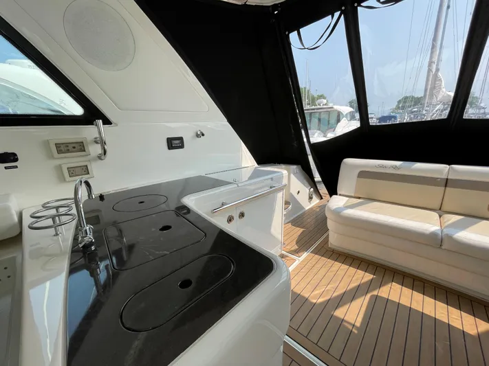  Yacht Photos Pics Interior of 2013 Sea Ray 450 Sundancer yacht with kitchenette and seating area.