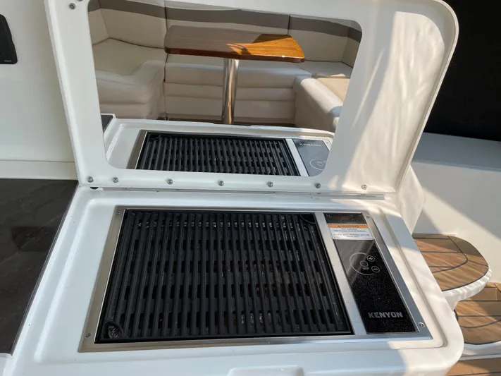  Yacht Photos Pics Outdoor grill on 2013 Sea Ray 450 Sundancer yacht, with seating area in background.