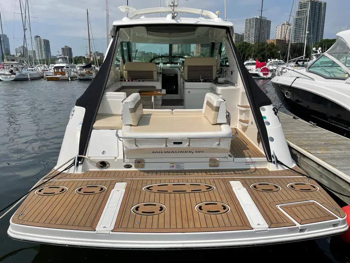  Yacht Photos Pics 2013 Sea Ray 450 Sundancer yacht docked at marina, featuring spacious deck and seating area.