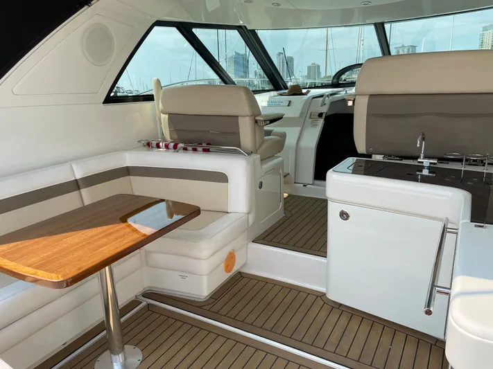  Yacht Photos Pics Interior of 2013 Sea Ray 450 Sundancer yacht with seating and wooden table.