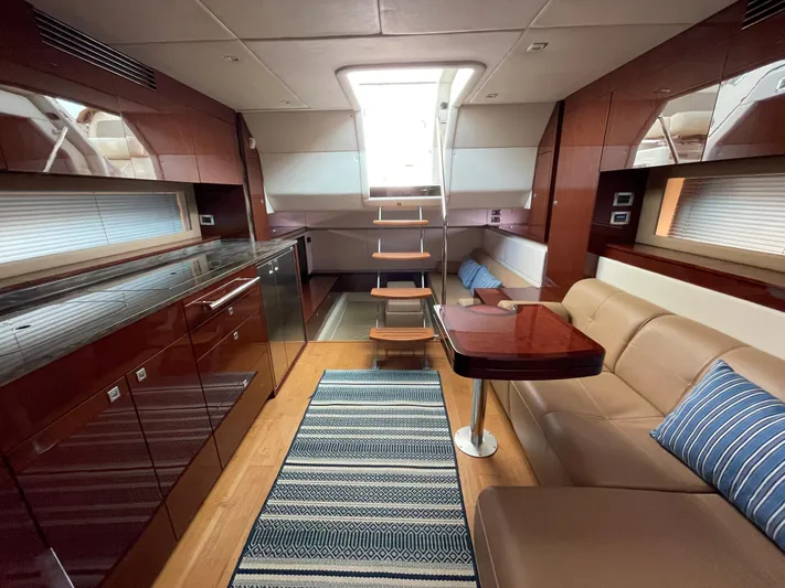  Yacht Photos Pics Luxurious interior of 2013 Sea Ray 450 Sundancer yacht with modern kitchen and seating area.