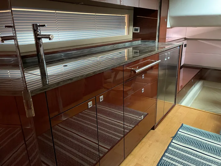  Yacht Photos Pics Luxurious kitchen interior of 2013 Sea Ray 450 Sundancer yacht with sleek cabinetry.