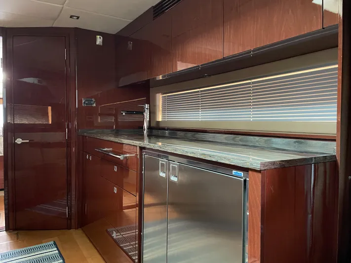  Yacht Photos Pics Luxurious kitchen interior of 2013 Sea Ray 450 Sundancer yacht with sleek cabinetry and modern appliances.