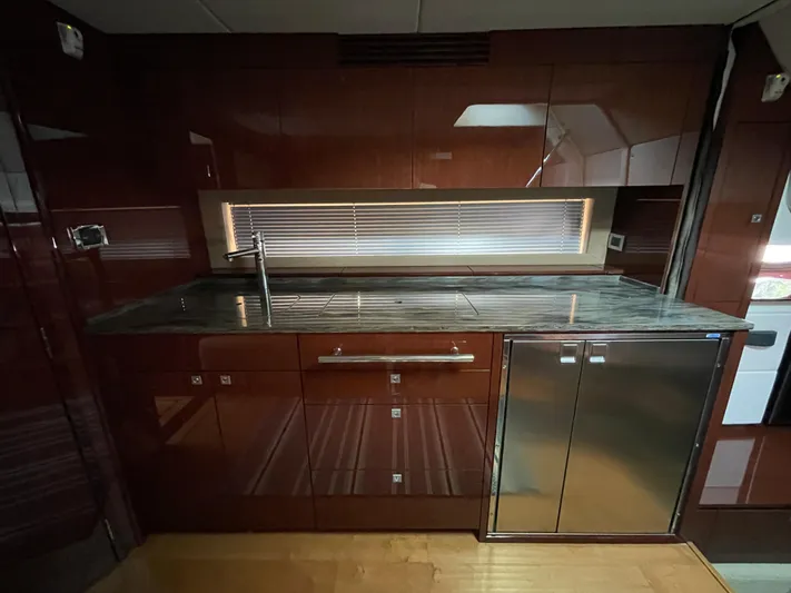  Yacht Photos Pics Luxurious kitchen interior of 2013 Sea Ray 450 Sundancer yacht with sleek cabinetry.