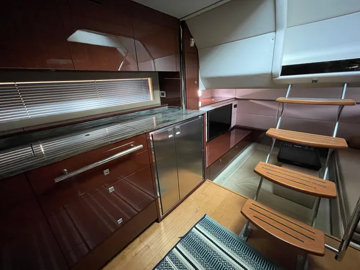  Yacht Photos Pics Interior of 2013 Sea Ray 450 Sundancer yacht with modern kitchen and wooden stairs.