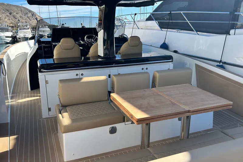  Yacht Photos Pics 2024 Solaris Power 44 Open yacht interior with seating and wooden table.