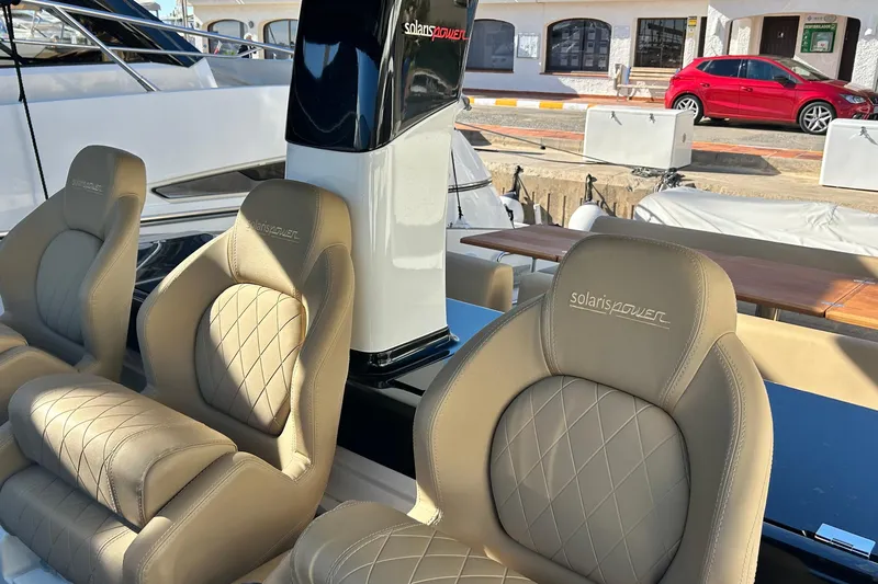  Yacht Photos Pics 2024 Solaris Power 44 Open yacht with luxurious beige seating and sleek design.