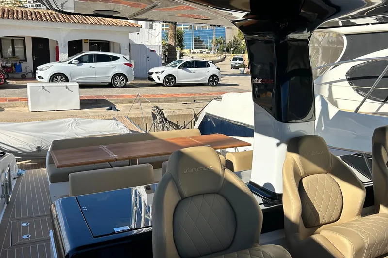  Yacht Photos Pics 2024 Solaris Power 44 Open yacht interior with luxurious seating and dining area.