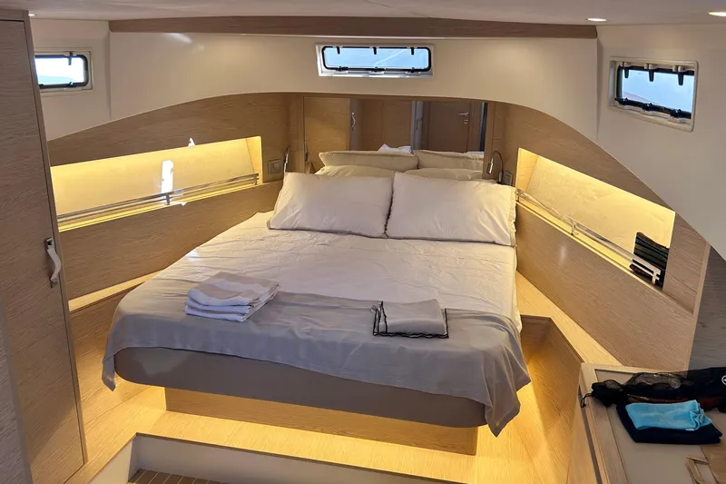  Yacht Photos Pics Luxurious cabin interior of 2024 Solaris Power 44 Open yacht, featuring a cozy bed and ambient lighting.