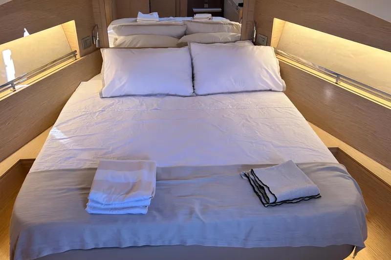  Yacht Photos Pics Luxurious cabin interior of 2024 Solaris Power 44 Open yacht with neatly arranged bedding.