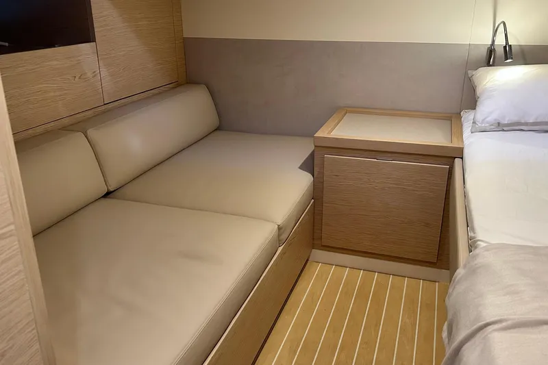  Yacht Photos Pics 2024 Solaris Power 44 Open cabin interior with beige seating and wooden accents.