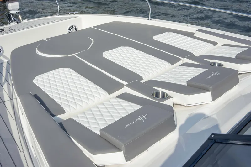  Yacht Photos Pics Luxurious sunbathing area on 2025 Hanover 387 yacht with cushioned seating and cup holders.