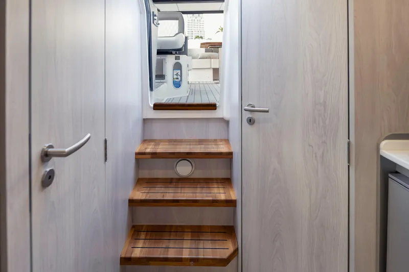  Yacht Photos Pics Interior view of 2025 Hanover 387 yacht, featuring wooden stairs and modern design.