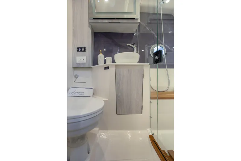  Yacht Photos Pics Modern bathroom in 2025 Hanover 387 yacht with sleek fixtures and glass shower.