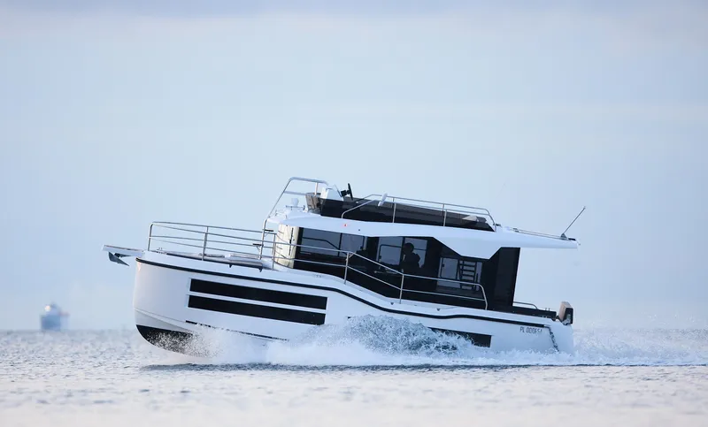  Yacht Photos Pics 2025 Northman 1050 boat cruising on open water, showcasing sleek design and modern features.