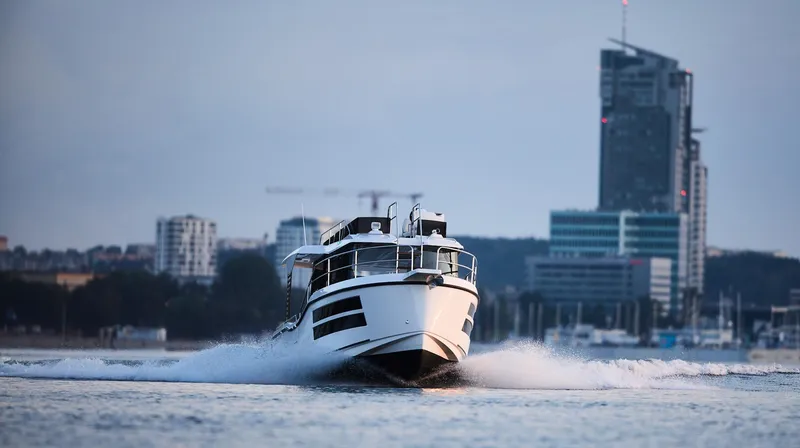  Yacht Photos Pics Modern Northman 1050 boat cruising near city skyline, 2025 model.