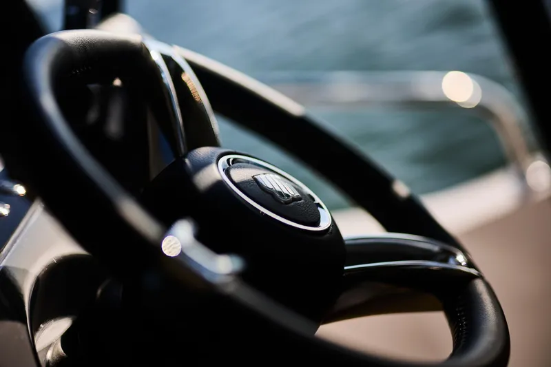  Yacht Photos Pics Steering wheel of 2025 Northman 1050 boat, close-up view with blurred background.