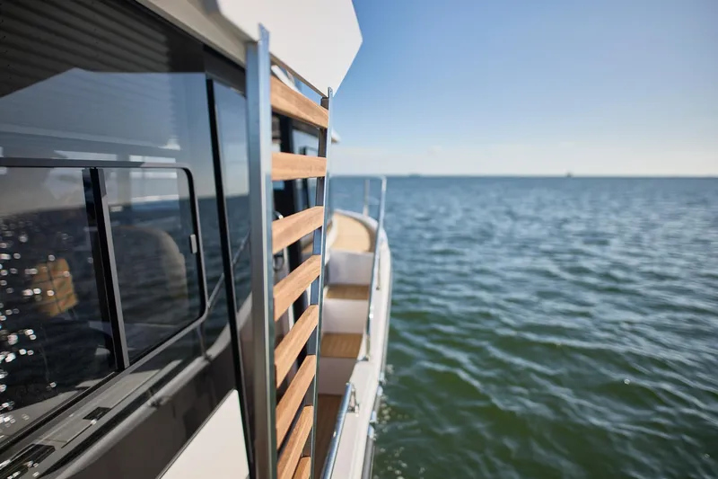  Yacht Photos Pics Modern Northman 1050 yacht on open water, showcasing sleek design and wooden accents, 2025 model.