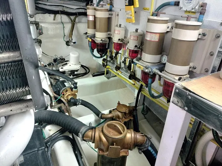 No Name Yacht Photos Pics Engine room of a 2001 Symbol 62 Pilothouse with fuel filters and piping.