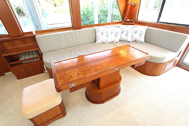 No Name Yacht Photos Pics Luxurious 2001 Symbol 62 Pilothouse interior with elegant wood table and plush seating.