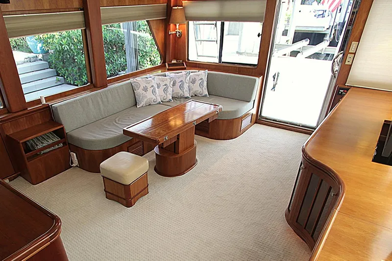 No Name Yacht Photos Pics Luxurious 2001 Symbol 62 Pilothouse interior with elegant wood finishes and cozy seating area.