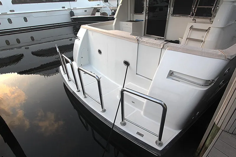 No Name Yacht Photos Pics 2001 Symbol 62 Pilothouse yacht stern view with stainless steel railings at dock.