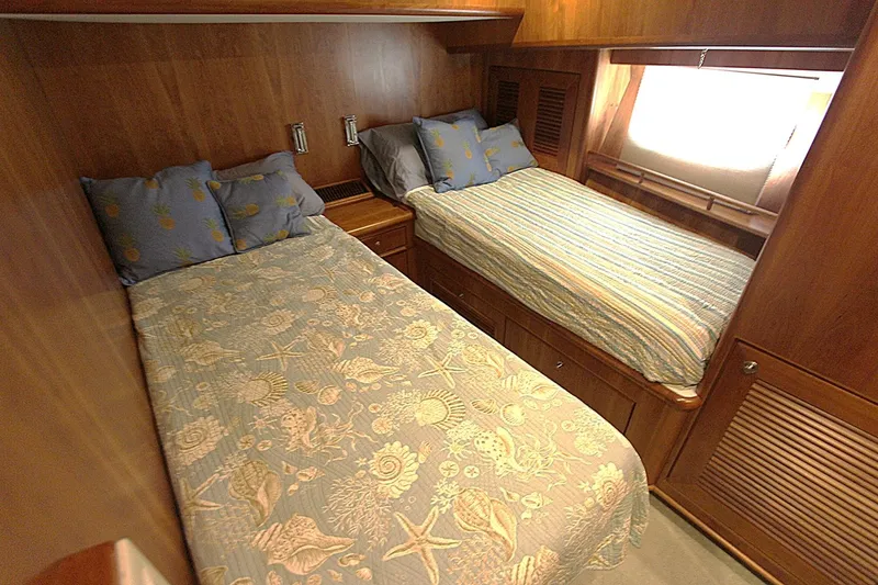No Name Yacht Photos Pics Cozy twin beds in 2001 Symbol 62 Pilothouse cabin with wooden interior.