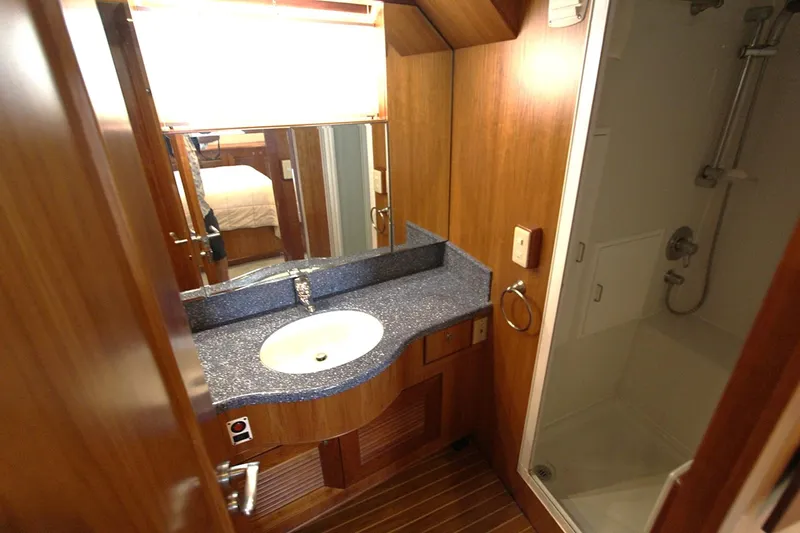 No Name Yacht Photos Pics Luxurious bathroom in 2001 Symbol 62 Pilothouse yacht with modern sink and shower.