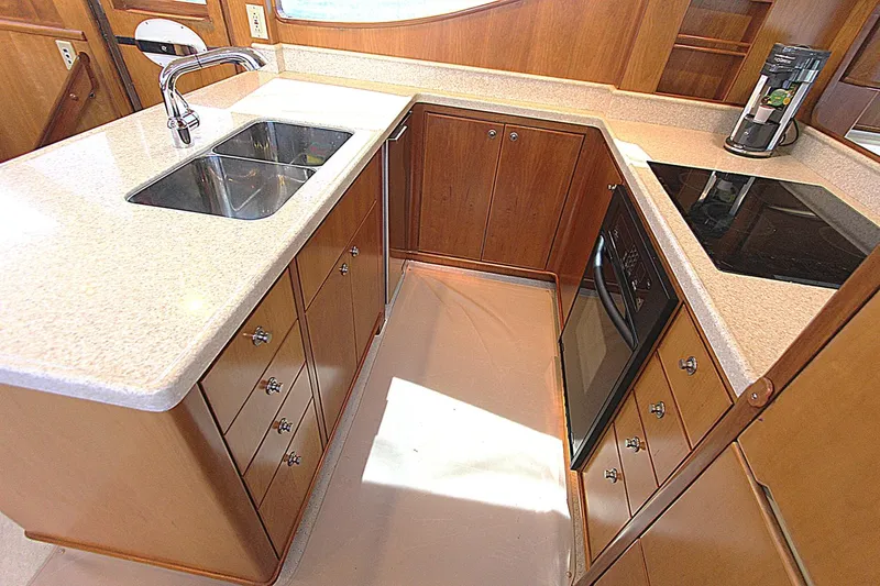 No Name Yacht Photos Pics Luxurious kitchen in 2001 Symbol 62 Pilothouse yacht with modern appliances and wood cabinetry.