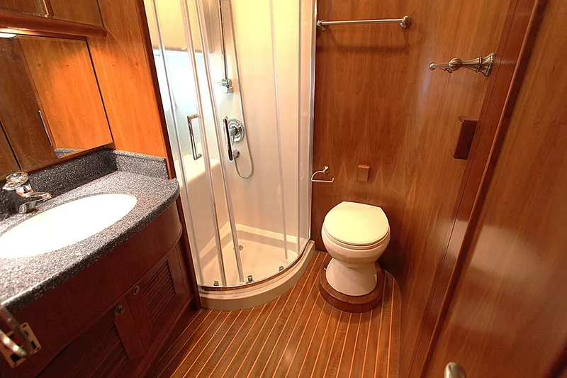 No Name Yacht Photos Pics Luxurious bathroom in 2001 Symbol 62 Pilothouse yacht with wood accents and modern fixtures.