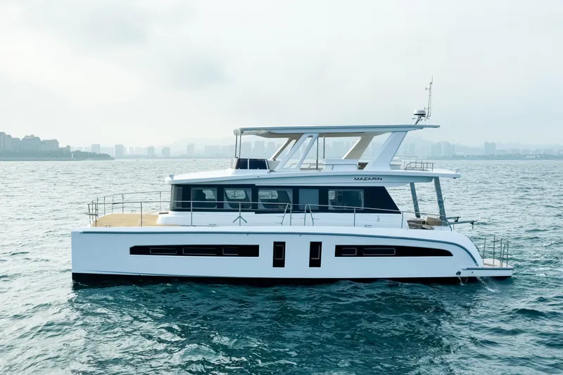  Yacht Photos Pics Modern 2025 Mazarin 55 EVO II yacht cruising on open water.