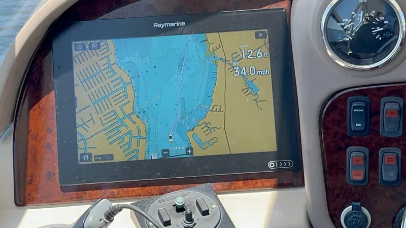 Roweboat Yacht Photos Pics Carver Voyager 2006 dashboard with Raymarine navigation display showing map and speed.