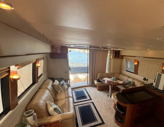 Roweboat Yacht Photos Pics Luxurious interior of 2006 Carver Voyager Sky Lounge yacht with elegant seating and decor.