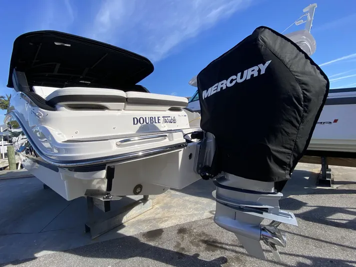 Double Trouble Yacht Photos Pics 2023 Sea Ray 260 SLX boat with Mercury engine cover, docked under clear blue sky.