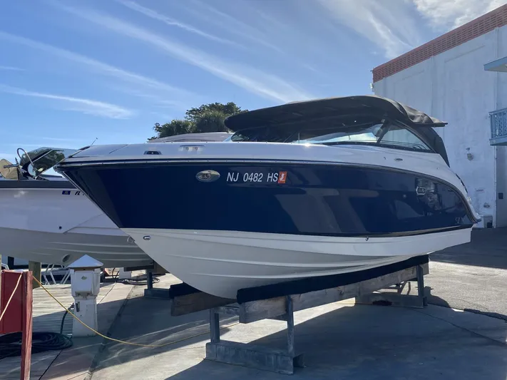 Double Trouble Yacht Photos Pics 2023 Sea Ray 260 SLX boat on display, blue and white exterior, parked outdoors.
